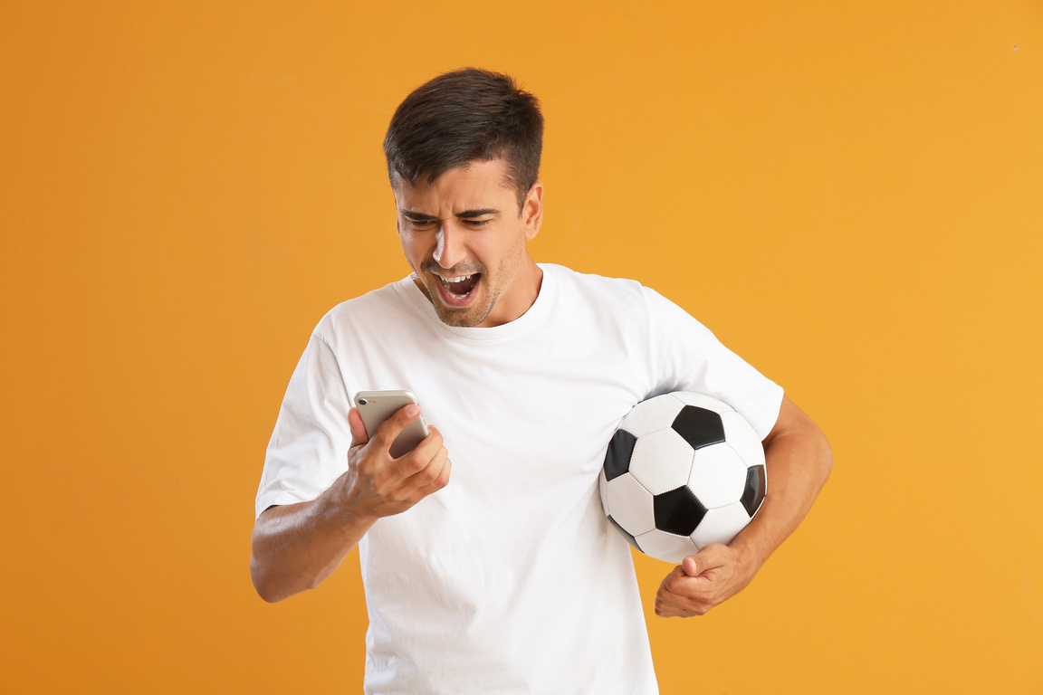 Emotional Man Placing Sports Bet on Color Background